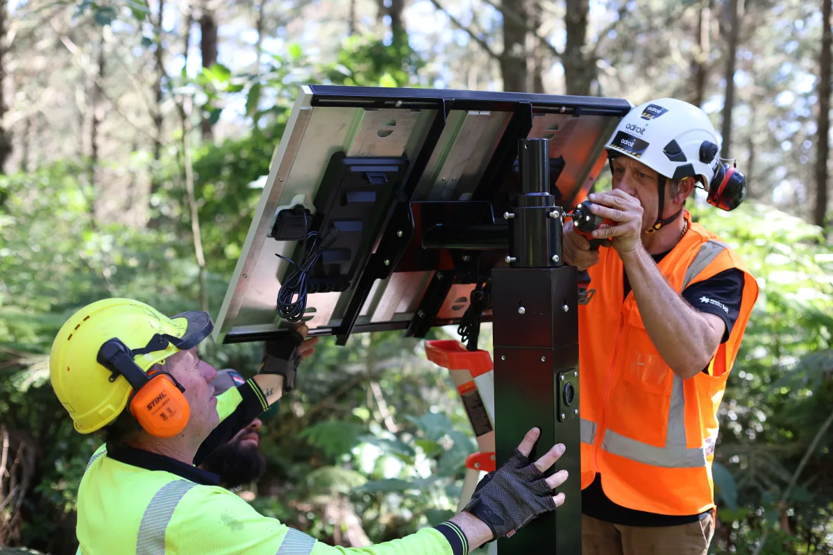 engineers installing and aligning gateway infrastructure